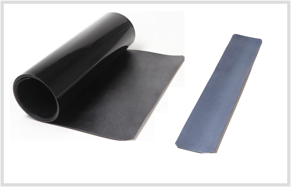 An unshrunk three-layer pipeline sleeve part-unrolled, glossy black on the outer face and matt adhesive on the inner face, photographed beside a separate rectangular closure patch strip